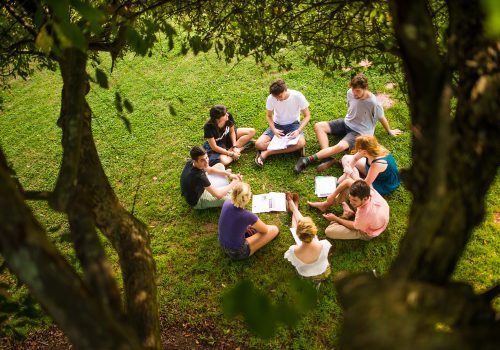 Students sitting in a circle on the quad